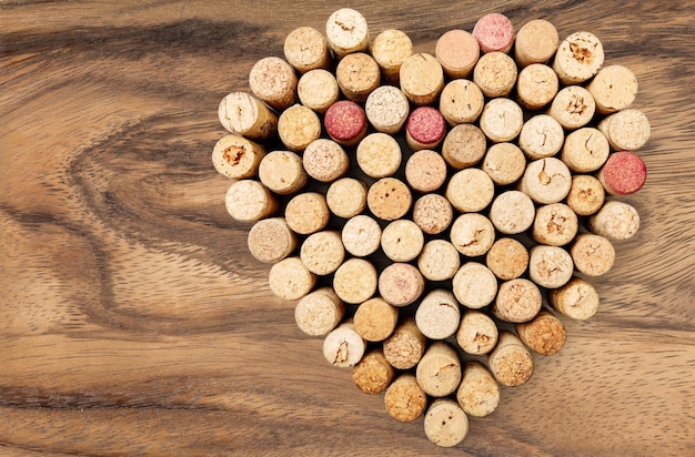 Close up of corks of wine placed in shape of heart on background