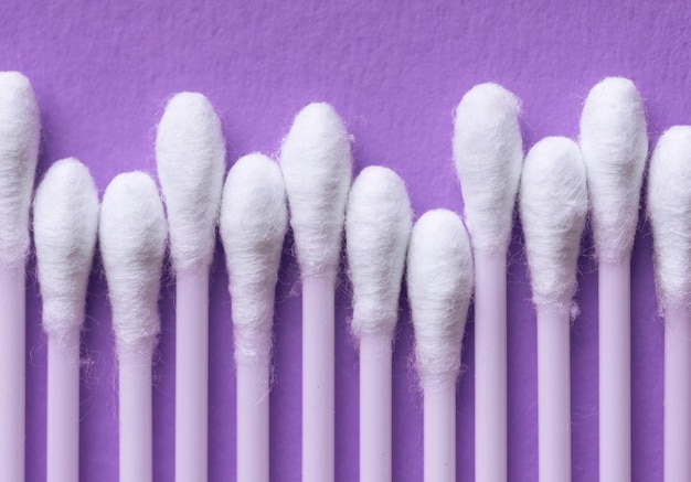 Close-up of cotton swabs arranged on blue table