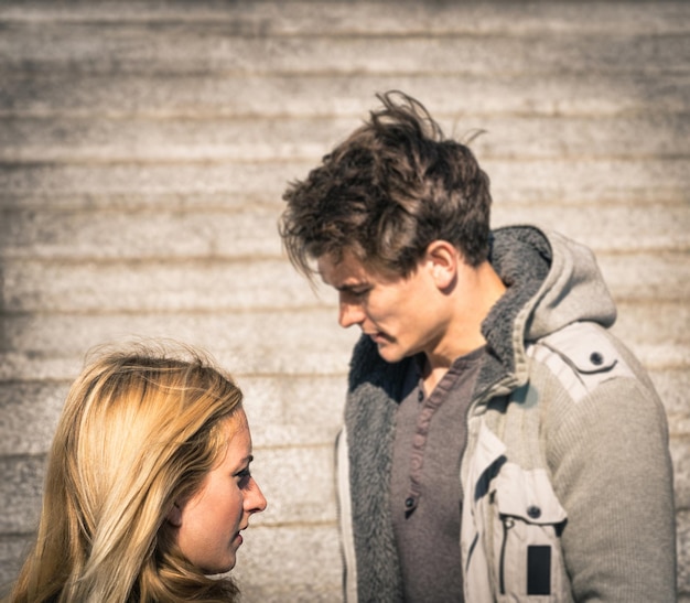 Close-up of couple against wall