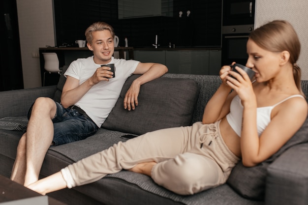 Close up on couple enjoying a drink together indoors