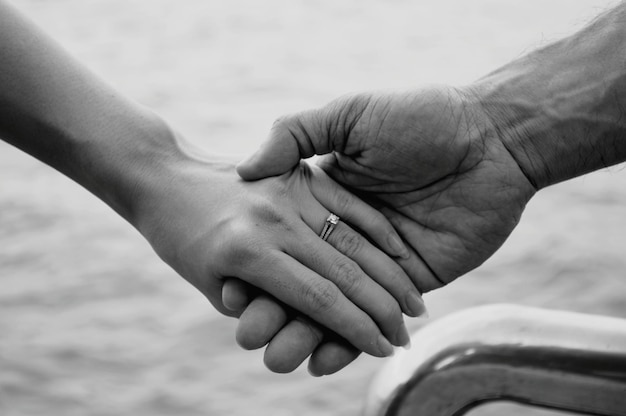 close-up of couple holding hands