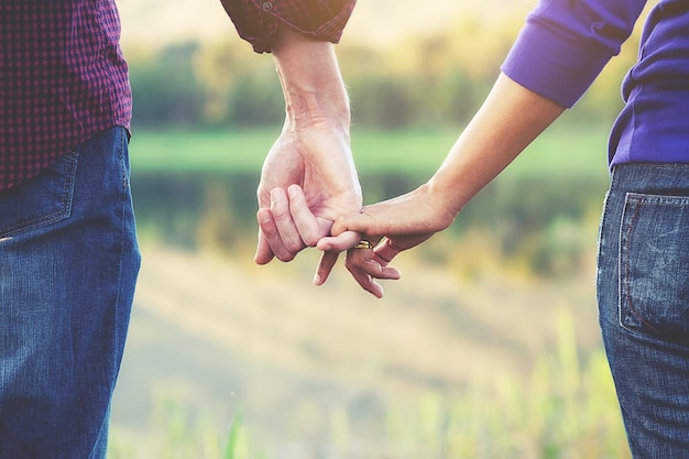 Close-up of couple holding hands