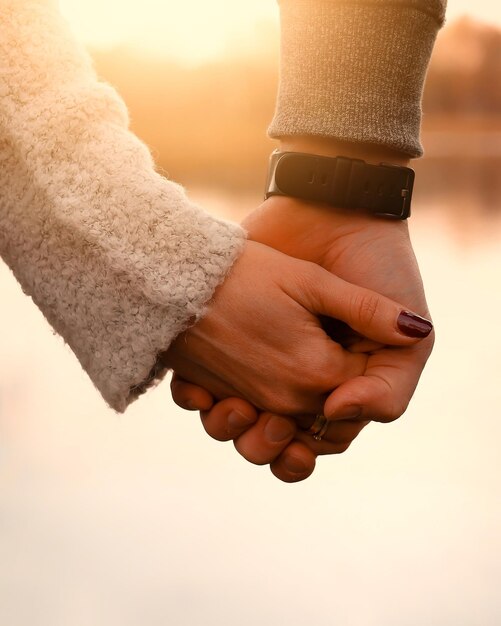 Close-up of couple holding hands