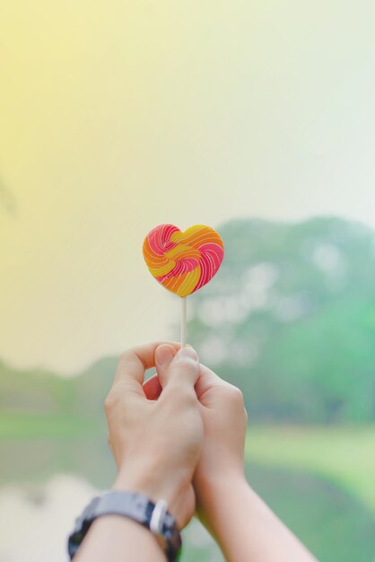 close-up of couple holding heart shape candy