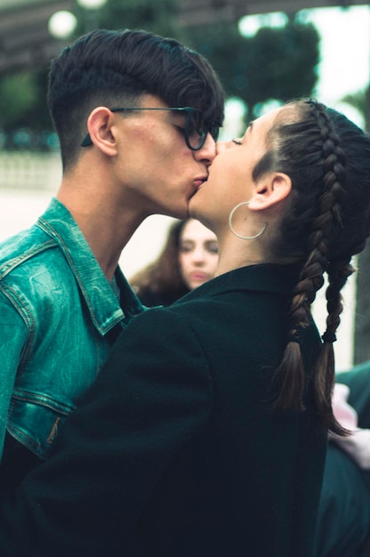 Close-up of couple kissing while standing outdoors