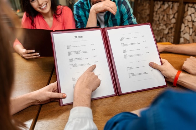 close up of couple with menu at restaurant