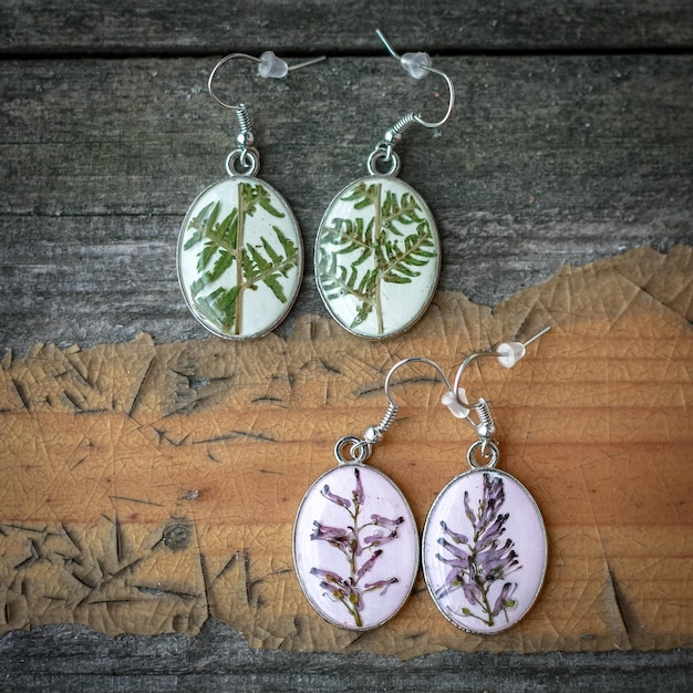 Close up craft earrings with lavender and fern concept photo