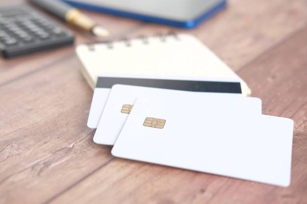 Close up of of credit cards and office stationary on table .