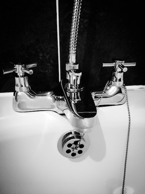 Photo close up of crome bath mixing taps