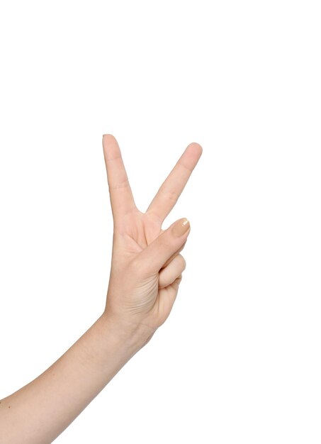 Photo close-up of cropped hand showing peace sign over white background