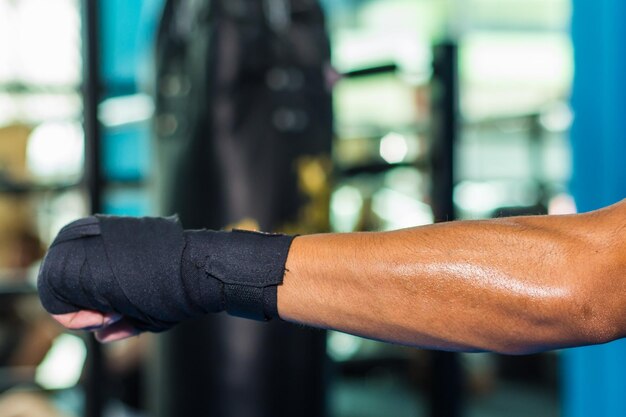 Photo close-up of cropped hand with boxing straps