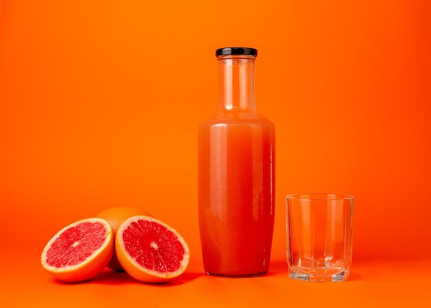 Close up cropped photo of female holding in hands half of fresh ripe grapefruit glass cup