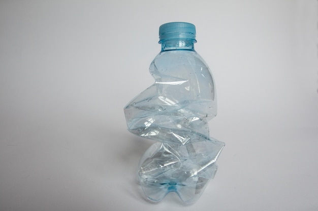 Photo close-up of crumpled bottle against white background