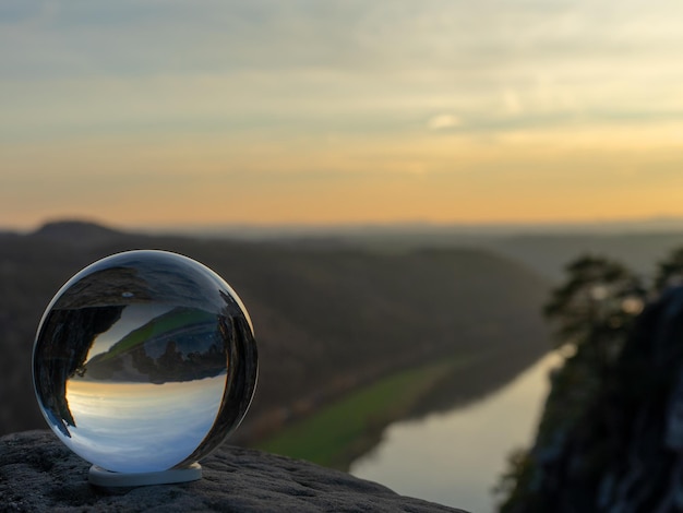 Photo close-up of crystal ball against sky during sunset