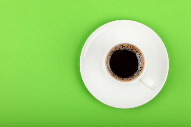 Close up on cup of black coffee on saucer