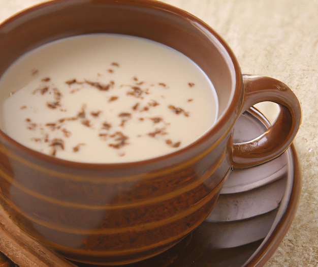 Close up of cup of chai tea over table created using generative ai technology