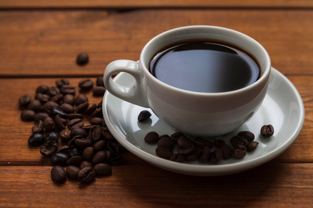 Close-up cup of coffee and beans