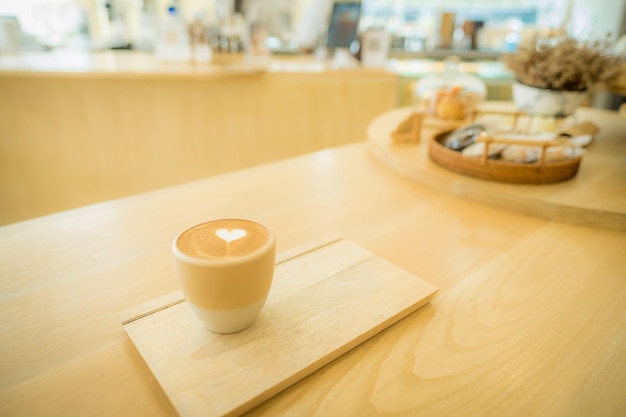 Close up cup of coffee with Cappuccino or latte art milk foam surface