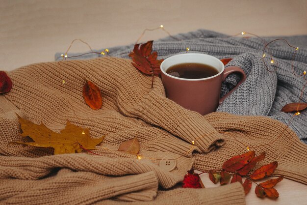 Close up cup of coffee with cozy sweaters