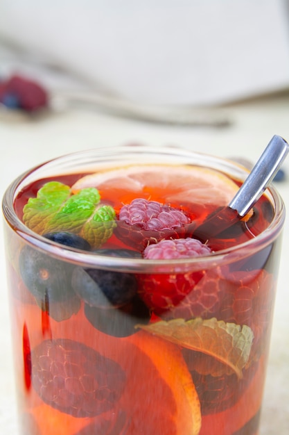 Close-up of a cup of tea and berry fruits