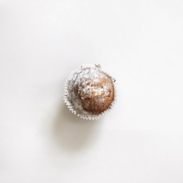 Photo close-up of cupcake over white background