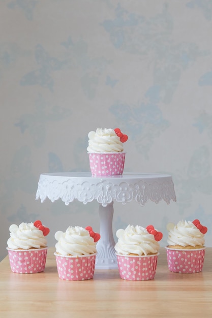 Close-up of cupcakes on table against wall