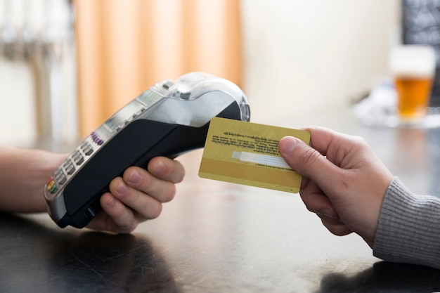 Photo close-up of customer paying by credit card