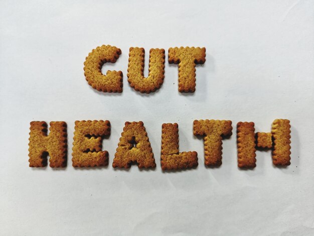 Photo close-up of cut health text made with cookies against white background