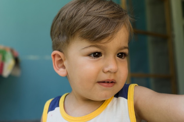 Close-up of cute baby boy looking away at home