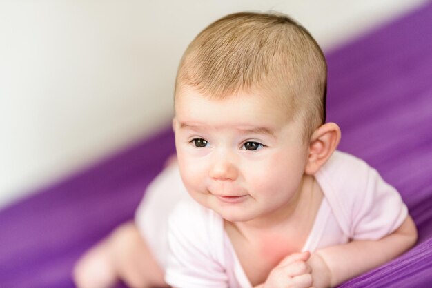 Close-up of cute baby girl at home