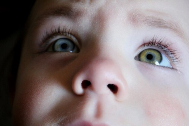 Close-up of cute baby girl looking away