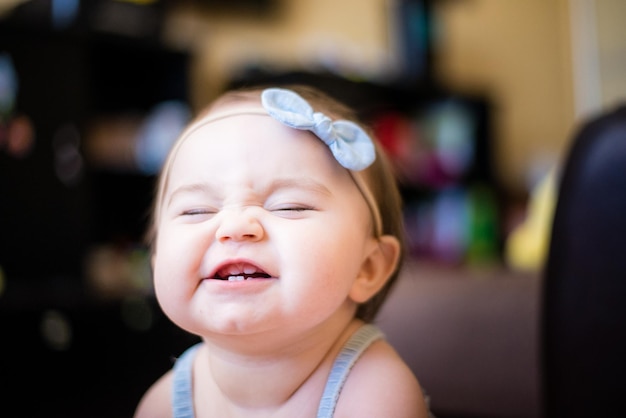 close-up of cute baby girl wearing headband at home