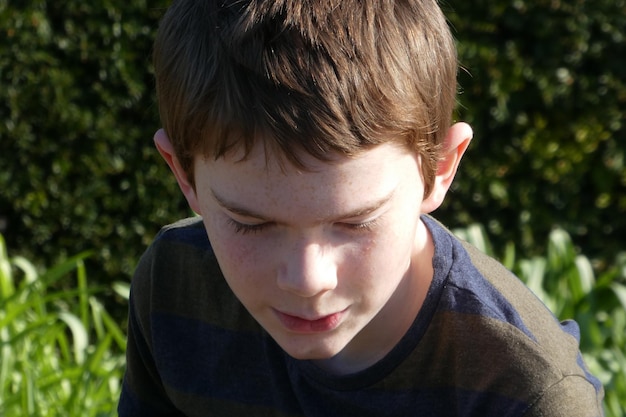 close-up of cute boy against plant