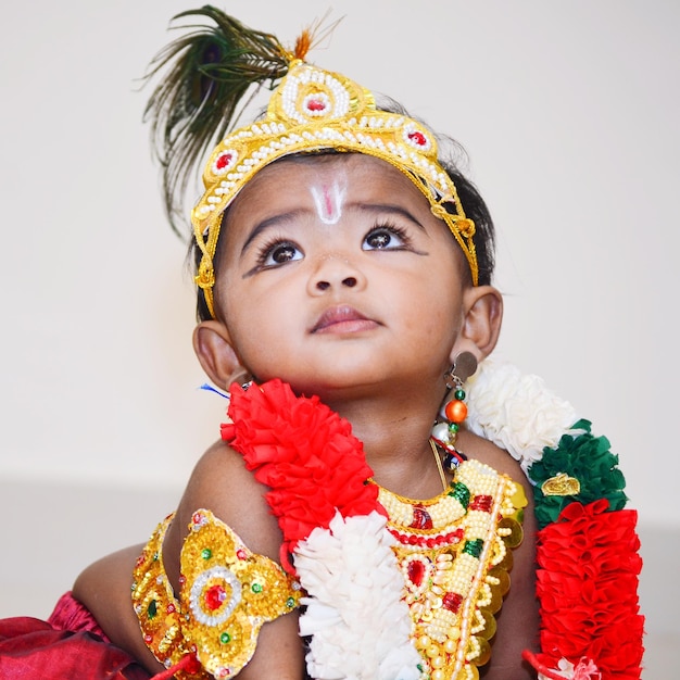 Foto close-up di una ragazza carina in costume di krishna che guarda a casa