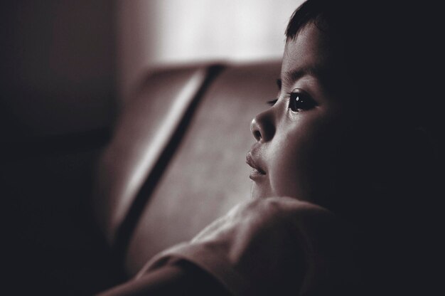 Close-up of cute girl looking away