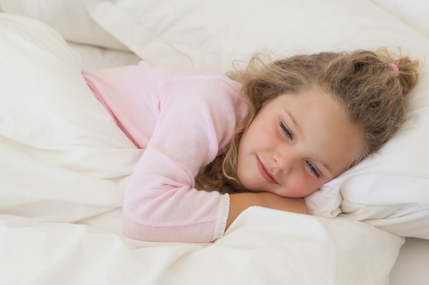 Close-up of a cute girl sleeping in bed