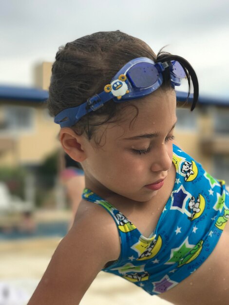 Close-up of cute girl wearing eyeglasses looking away