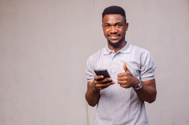 Close up of a cute man using his phone and smiling