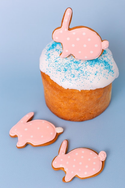 Close up of cute pink gingerbreads in the form of a rabbit on easter cake