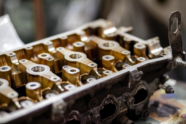 A close up of a cylinder head with the word engine on it