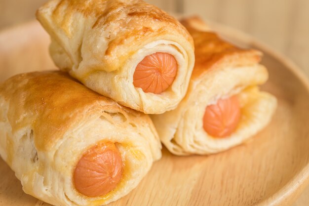 Close up Danish Pastry with sausage on wooden dish