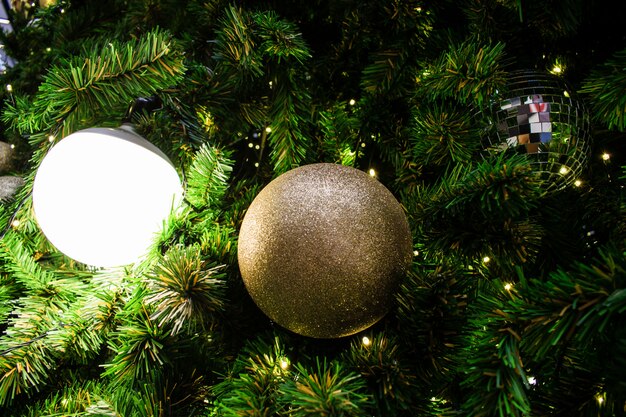 Close up decorated Christmas tree in silver and gold theme.