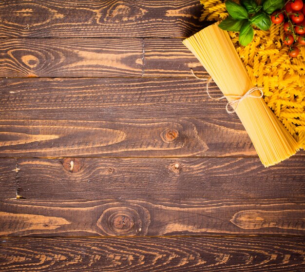 Close-up of decorating Italian pasta. On a wooden background