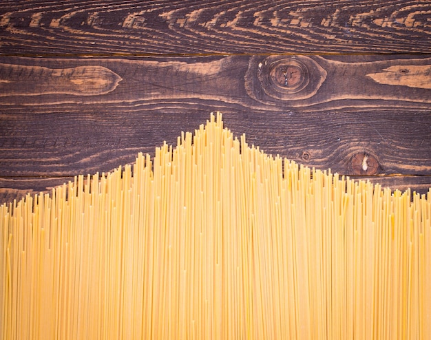 Close-up of decorating Italian pasta. On a wooden background