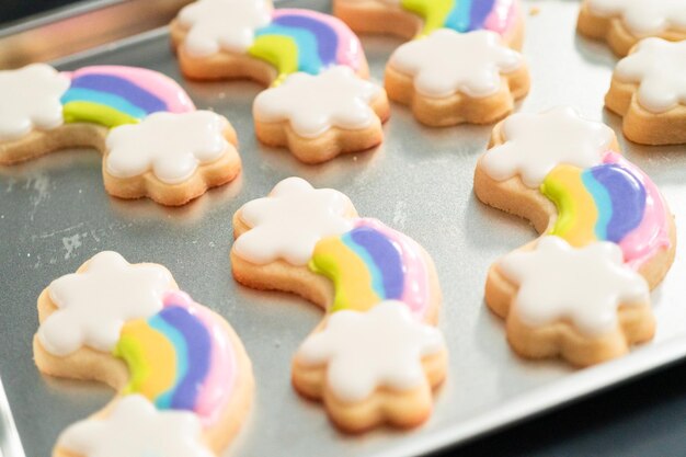 Close up. Decorating unicorn themed sugar cookies with royal icing.