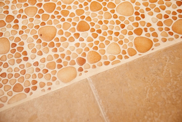 Close-up decorative beige square tile for walls and floor in the bathroom