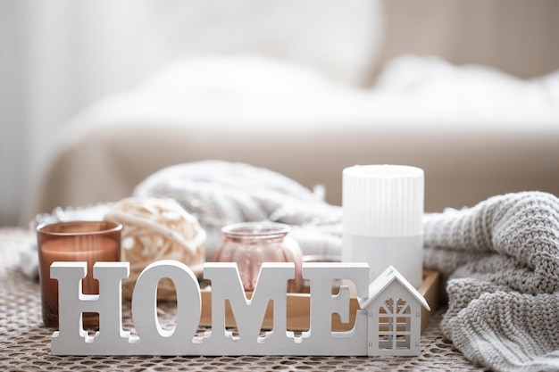 Close up decorative word home on blurred background with candles