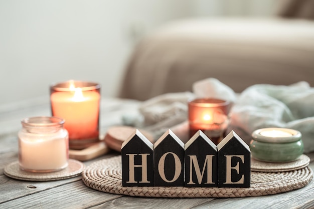 close up decorative word home on blurred background with candles