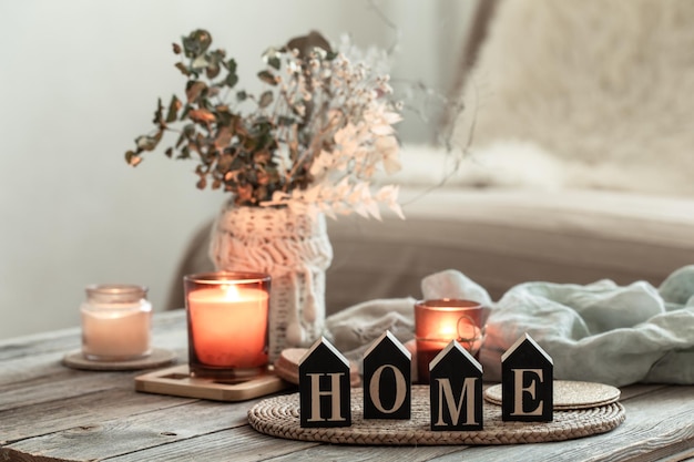 Close up decorative word home on blurred background with candles