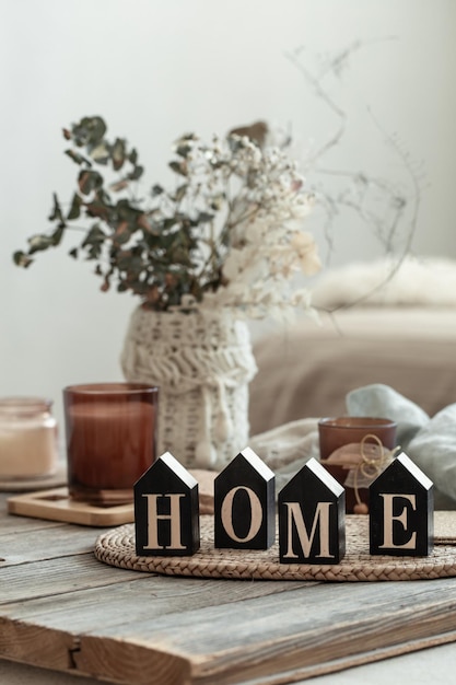 Close up decorative word home on blurred background with candles